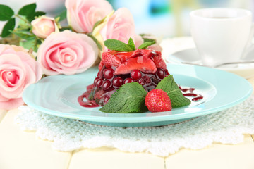 Tasty jelly dessert with fresh berries, on bright background