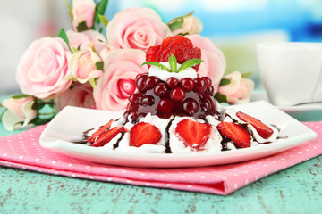 Tasty jelly dessert with fresh berries, on bright background