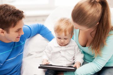 parents and adorable baby with tablet pc