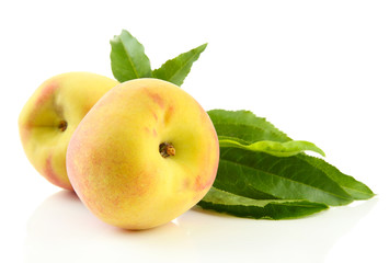 Ripe sweet peaches with leaves, isolated on white