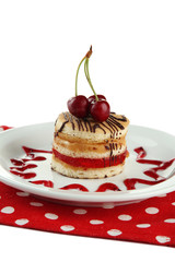 Tasty biscuit cake on plate isolated on white