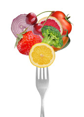 Vegetables and fruits on forks. Isolated on white