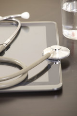 Doctor workplace with digital tablet and stethoscope