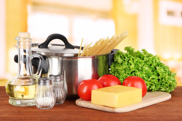 Ingredients for cooking pasta on table in kitchen
