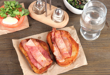 Bacon on toast on wooden table