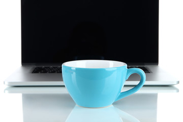 Blue cup on laptop background isolated on white