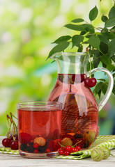 Pitcher and glass of compote with summer berries
