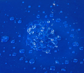 Water drops on blue plastic background