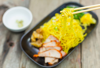 Chinese noodles with roast pork and vegetable.
