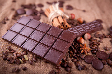 bar of chocolate with spices on a burlap background
