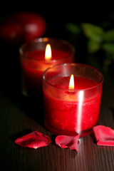 Beautiful romantic red candles with flower petals
