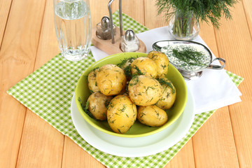 Boiled potatoes on platens on on napkins on wooden table