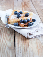 Crepes with blueberries and sugar powder
