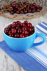 Sweet cherry in cup on table close-up