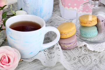 Macaroons in bowl on wooden table close-up