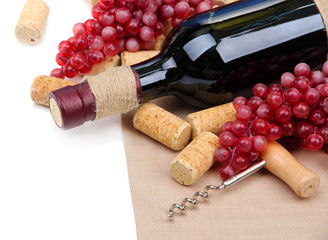 Bottles of wine, grapes and corks, isolated on white