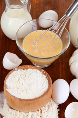 Ingredients for dough on wooden table close-up