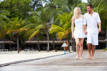Fototapeta premium Couple Walking On Wooden Jetty