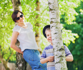 Smiling mother looking after her son