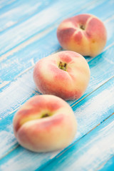 Donut saturn peaches on wooden boards, studio shot