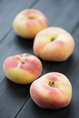 Peach donuts on black wooden boards, vertical shot