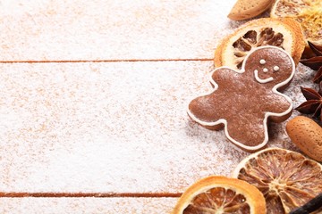 Gingerbread cookie and spices on sugar background