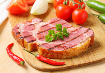 Grilled pork steak and fresh vegetables