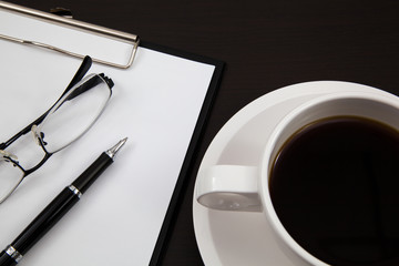 Cup of coffee and paper