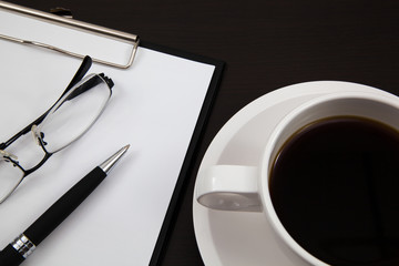 Cup of coffee and paper