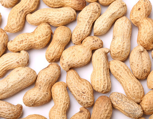 background from the raw peanuts scattered on white