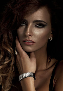 Fashion portrait of young beautiful woman with diamond jewelry
