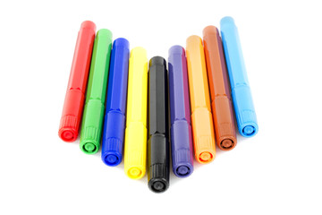 many colored pencils in row over white background