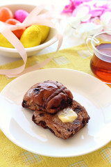 Chocolate hot cross buns with butter and easter eggs