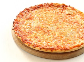 Pizza with cheese on a wooden tray.