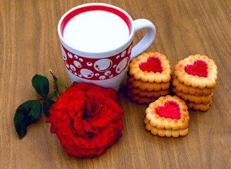Heart-shaped cookies,  rose and a cup of milk