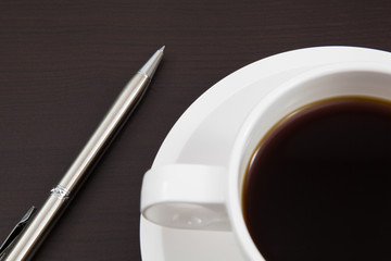 Fototapeta na wymiar Coffee cup and pen