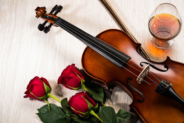 Fototapeta premium Violin, rose, glass of champagne and music books