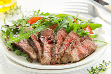 roast beef with salad of arugula and tomatoes.