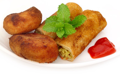 Potato chops with tomato ketchup and fresh mint leaves