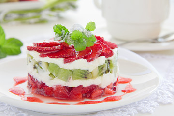 Summer dessert with strawberries, kiwi and vanilla cream.