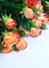 beautiful bouquet of roses on wooden table with place for text,