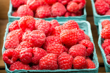 Fresh red raspberries on display at the market