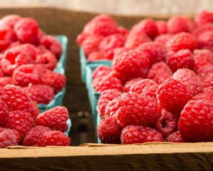 Fresh red raspberries on display at the market