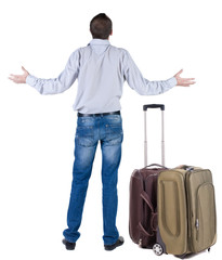 Back view of shocked business man with suitcase looking up.