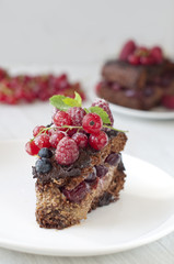 Fototapeta na wymiar Chocolate cake with strawberry and raspberry and cherries