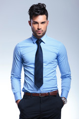 Fototapeta premium business man looks at you with hands in pockets