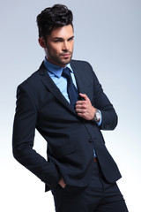 business man with hand on suit jacket