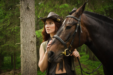 Fototapeta premium Cowgirl with brown horse
