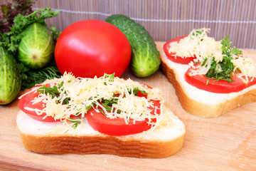vegetarian sandwich with tomato, cheese and greens
