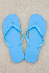blue flip flops on the beach